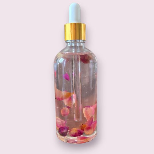 Flacon d'huile de rose pour le corps en grand format, extrait naturel de roses marocaines pour une hydratation intense.